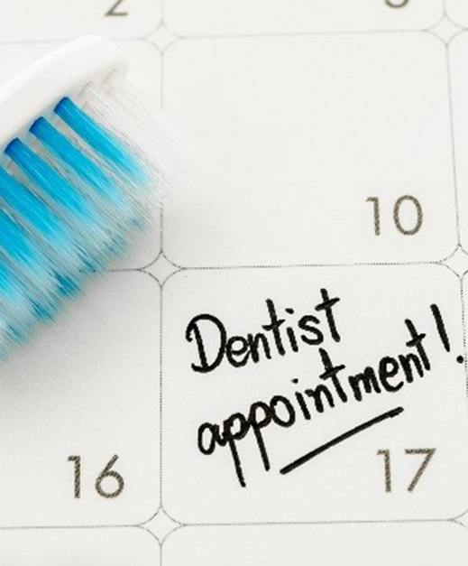 Toothbrush and dentist appointment on calendar 