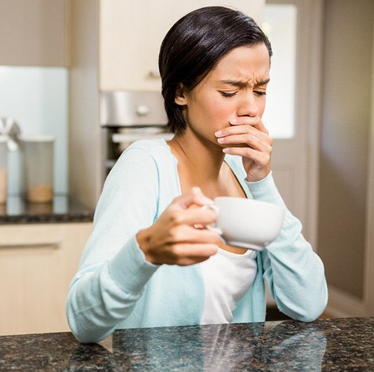 woman coffee toothache for root canal therapy in Columbus