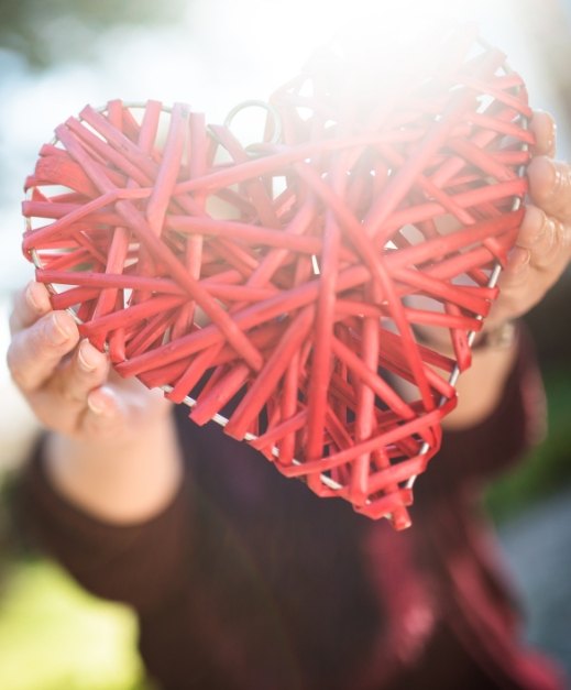 Person holding up a red heart