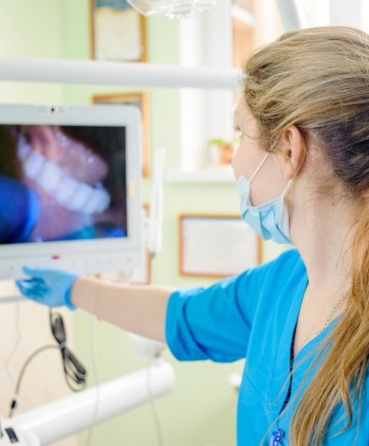 Dentist looking at images captured with intraoral camera