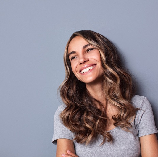 Smiling woman on a gray background