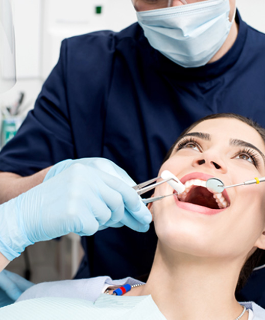 a patient having her teeth examined during a dental checkup
