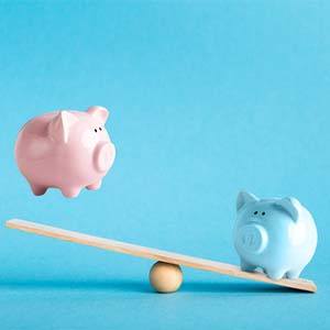 Piggy banks on balance scale