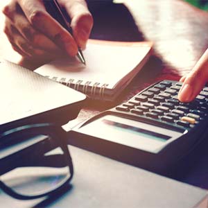 Woman calculating the cost of cosmetic dentistry in Columbus