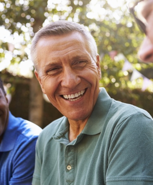 Man smiling and enjoying the benefits of dental implants