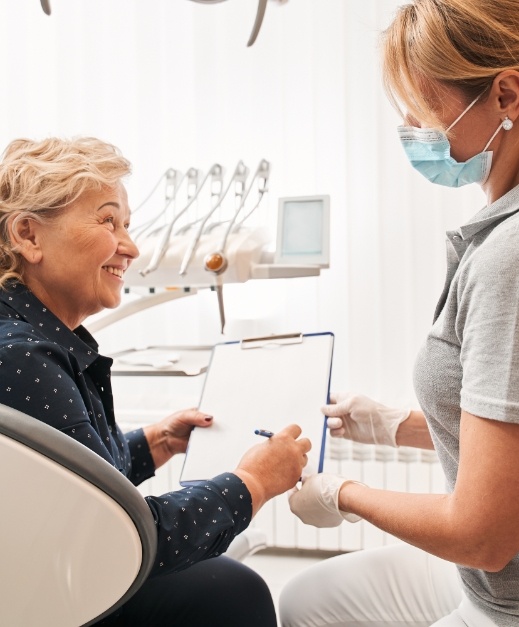 Dentl team member and patient reviewing dental insurance forms