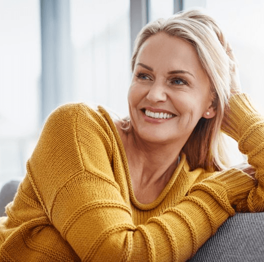 a woman in Columbus smiling with her new dentures