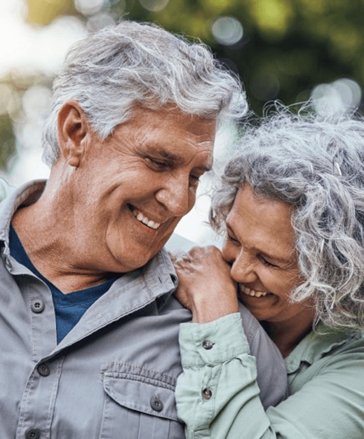 a mature couple with dentures smiling together