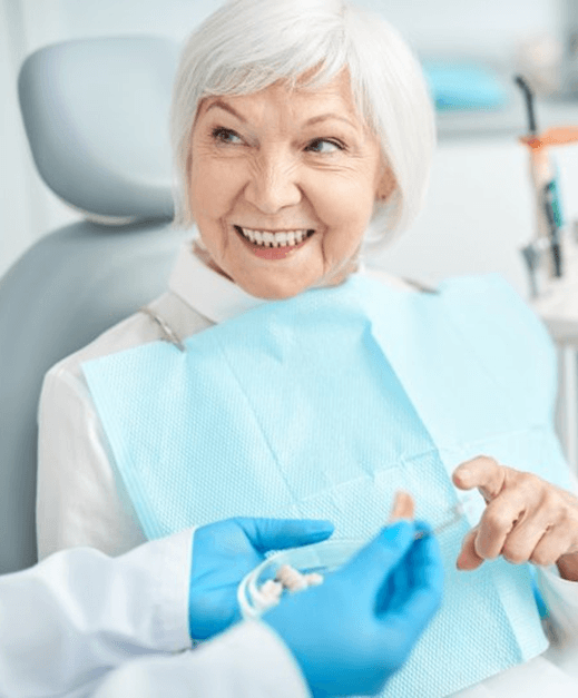 a patient smiling after receiving her dentures in Columbus