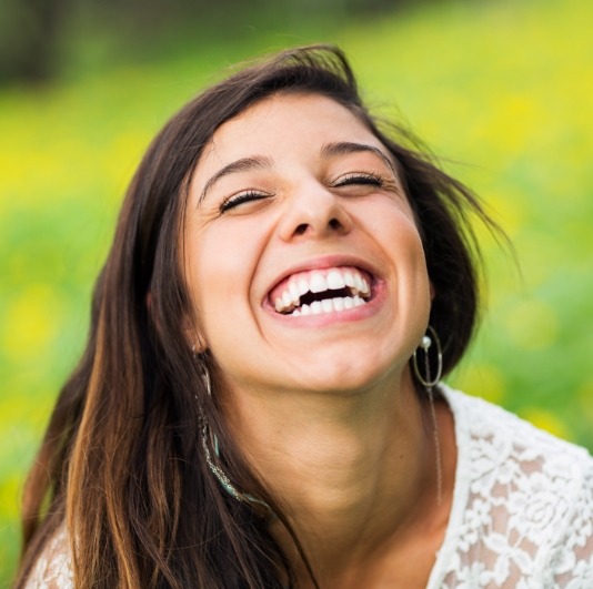 Woman with healthy smile after periodontal disease treatment