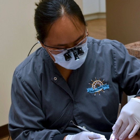 Dental team member providing emergency dentistry treatment