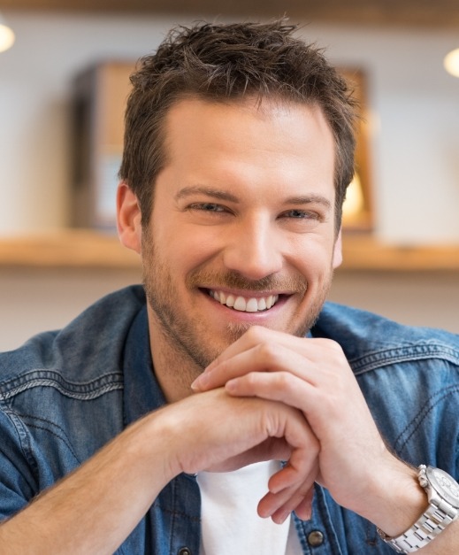 Man smiling after tooth extractions