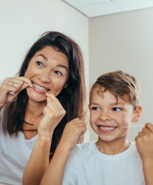 Woman flossing teeth to prevent dental emergencies