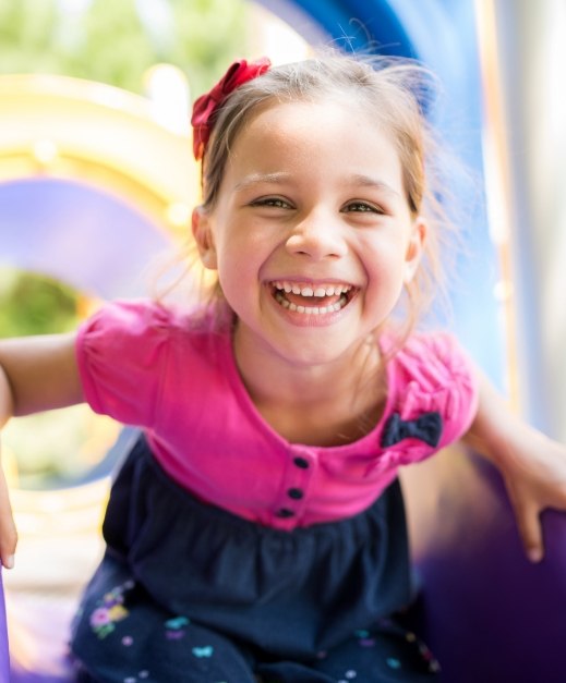 Child laughing after tooth colored filling treatment