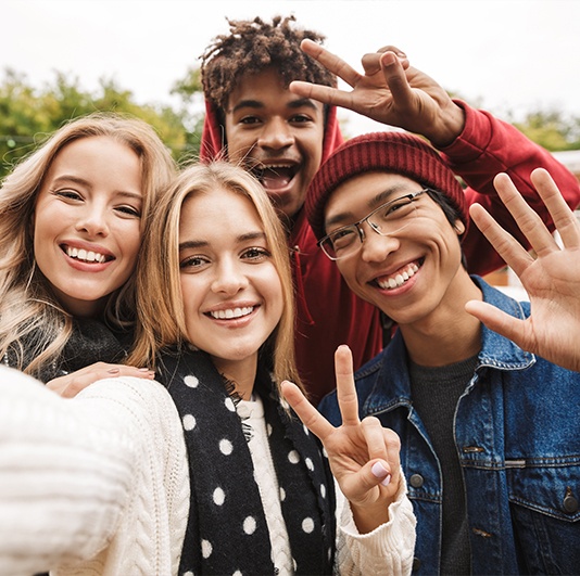 Group of young adults smiling after wisdom tooth extractions