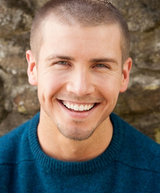 Man smiling after wisdom tooth extractions