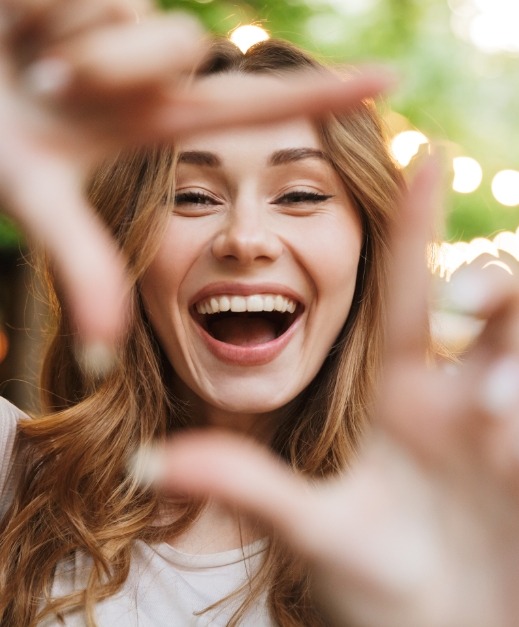 Woman framing her smile after smile makeover