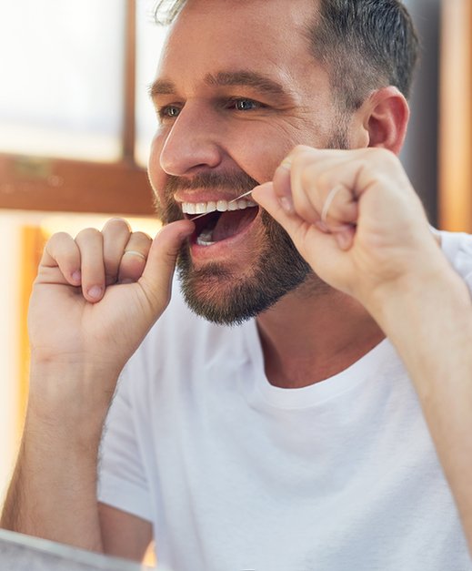 Man flossing his teeth