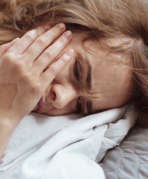woman toothache in bed for root canal therapy in Columbus