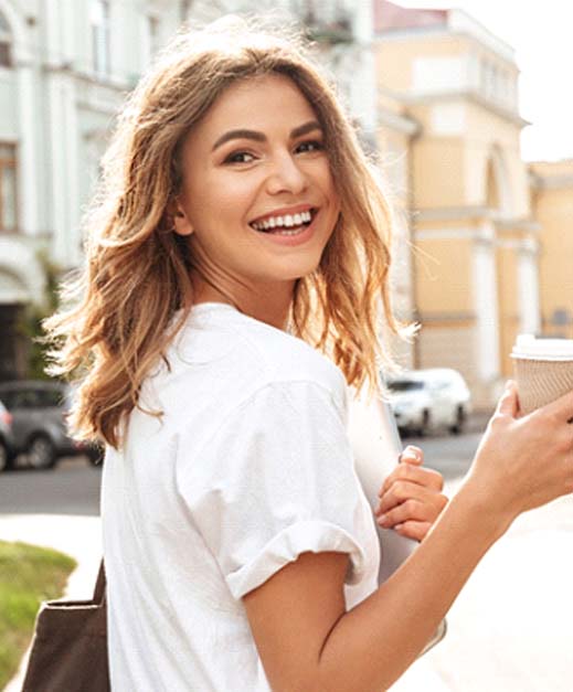 Woman with veneers in Columbus smiling outside