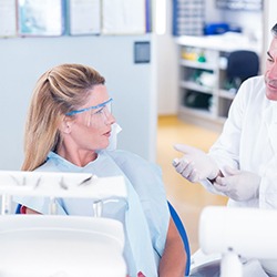 Dentist explaining cost of teeth whitening in Columbus to patient