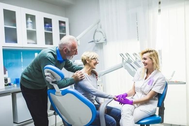 couple learning about dental financing at dental office 