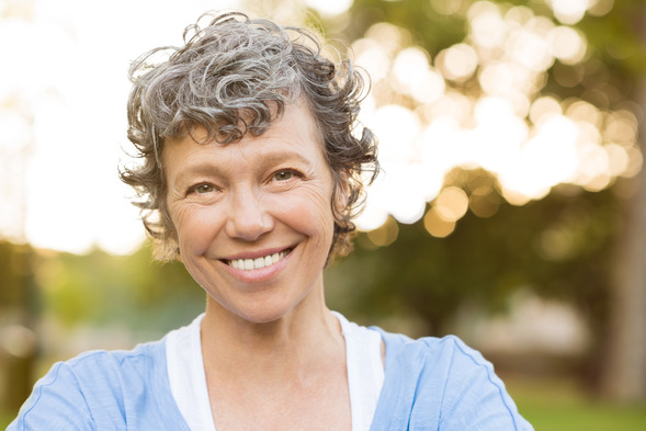 person smiling after getting dental implants