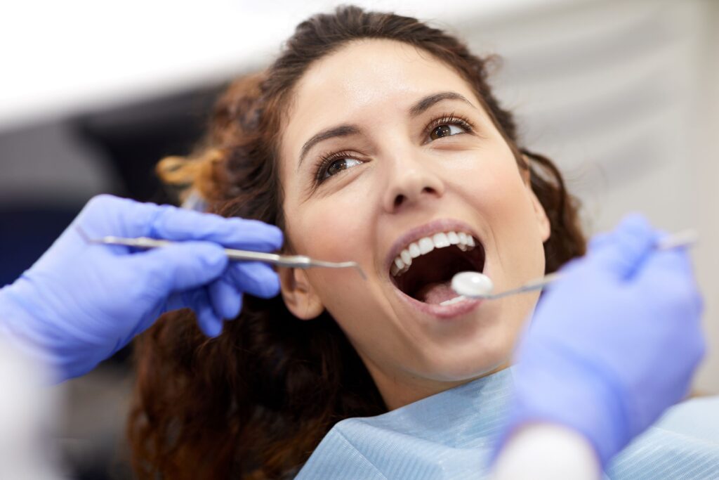 Woman with curly hair undergoing dental exam