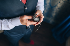Man looking down at a pocket watch