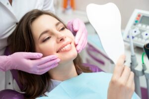 Woman looking at her cosmetic dentistry results