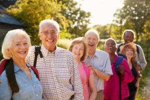 Group of happy seniors hiking outdoors