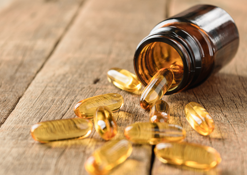 Vitamin bottle with capsules spilling out
